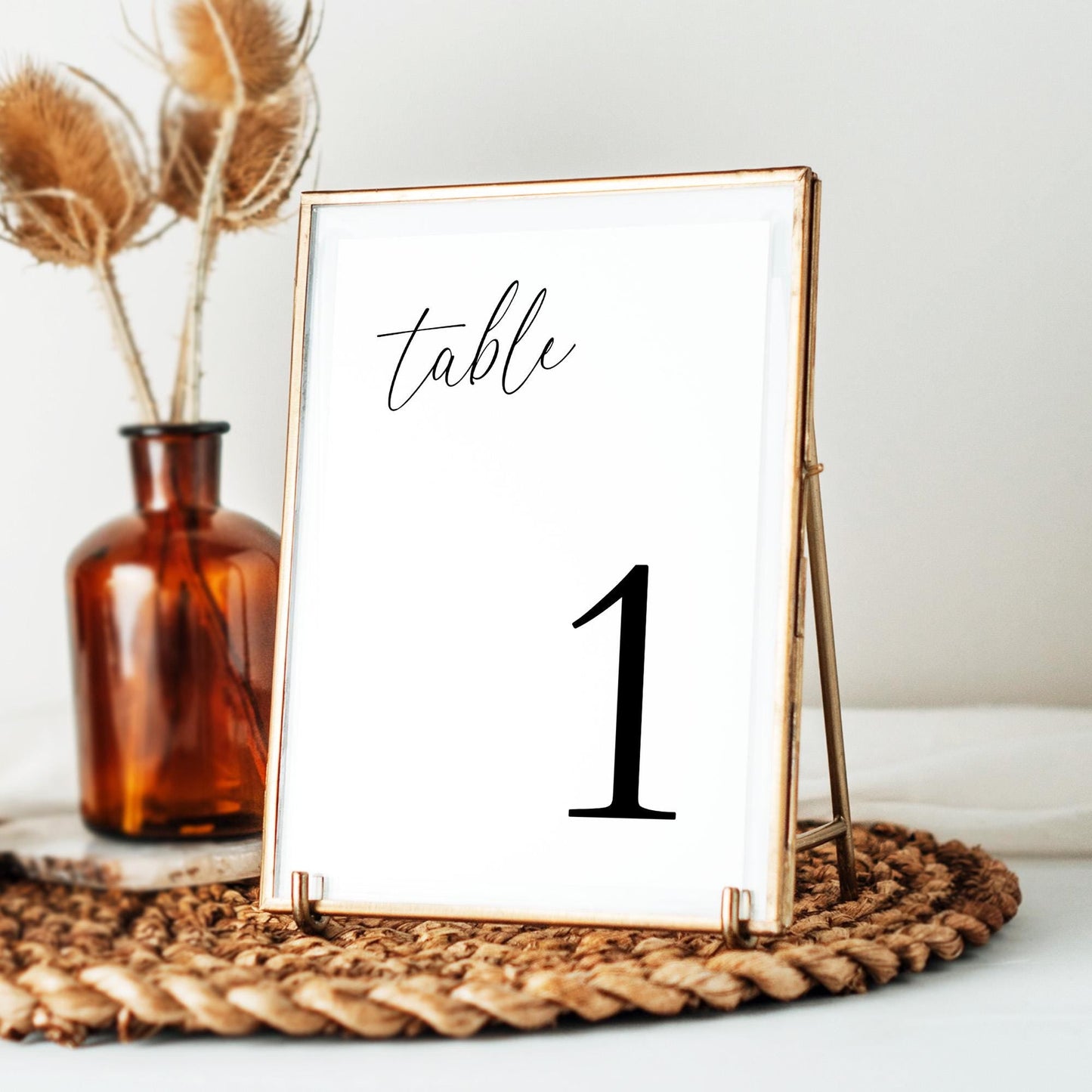 A table number card with &#39;table&#39; written in the left top corner in script font, and a large number 1 in the bottom right corner.
